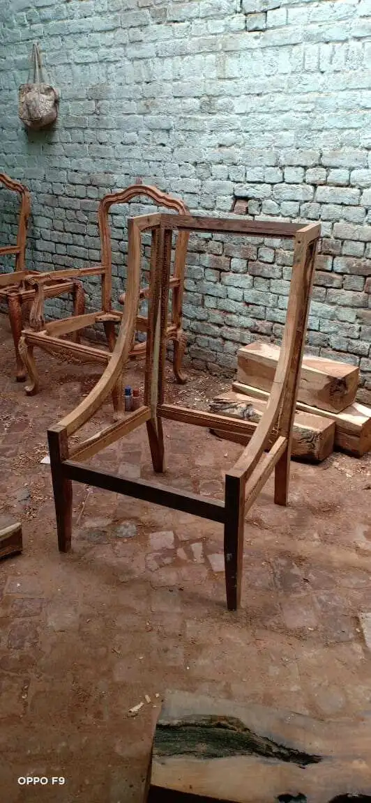 Modern curved wooden chair handcrafted in raw Sheesham wood with ergonomic backrest design by Cladsi