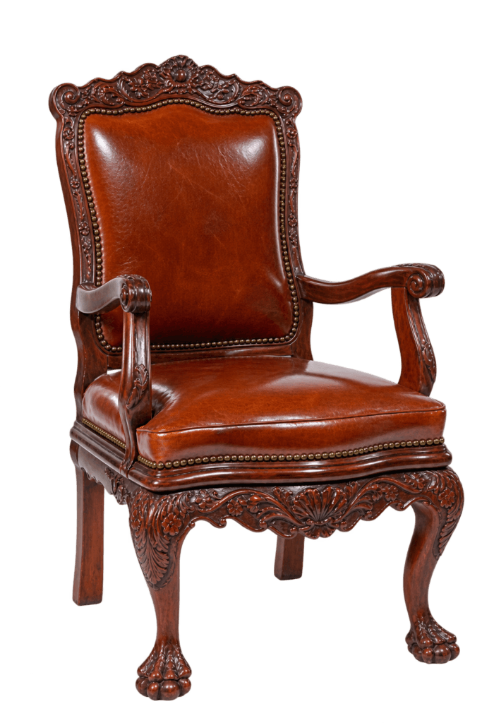 An ornate, antique-style wooden armchair with rich brown leather upholstery, intricate carvings, and classic claw-and-ball feet on a black background.