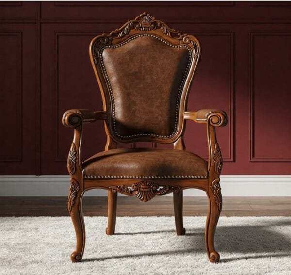 An ornate wooden armchair with brown leather upholstery and intricate carved details, positioned on a white rug against a dark red paneled wall.
