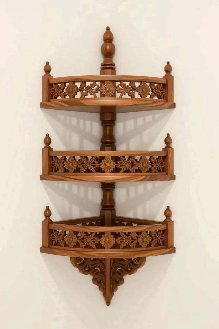 A three-tiered Traditional Corner Wooden Shelf mounted on a wall, featuring intricate floral carvings and a rich, polished wood finish.