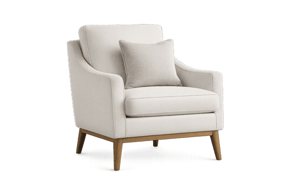 A modern cream-colored armchair with a matching throw pillow and light wooden legs, isolated against a plain black background for our About Us page.
